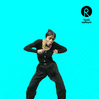 a woman in a black shirt and black pants is dancing in front of a blue background that says teatr rozbark