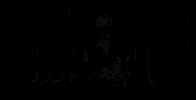 a man is standing in front of a wall of lights and smoke