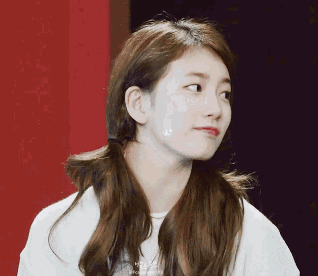 a close up of a woman 's face with a sticker on her cheek that says ' pudding ' on it