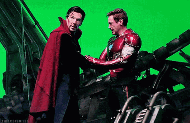 doctor strange and tony stark are shaking hands on a green screen