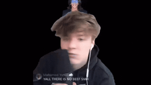 a young man wearing ear buds and a black hoodie says yall there is no beef smh on a black background