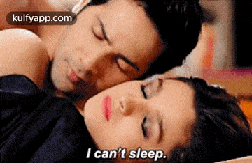 a man and a woman are sleeping in a bed and the woman is saying `` i can 't sleep . ''