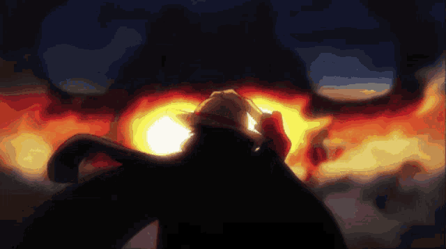 a man in a straw hat stands in front of a fireball