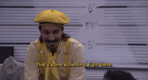 a man wearing a yellow hat and suspenders says " that 's some scheming right there "