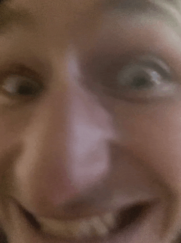 a close up of a person 's face with their mouth open .