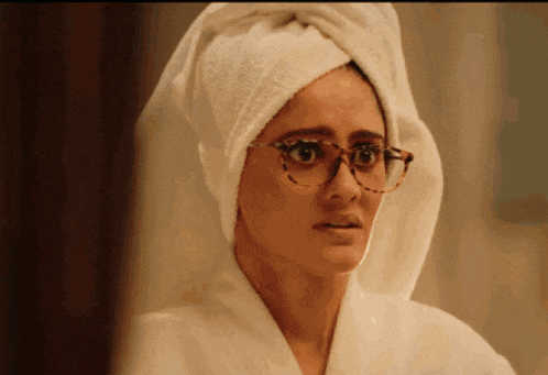 a woman with a towel wrapped around her head and glasses