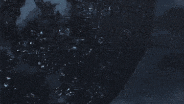 a blurred image of a person standing in front of a globe