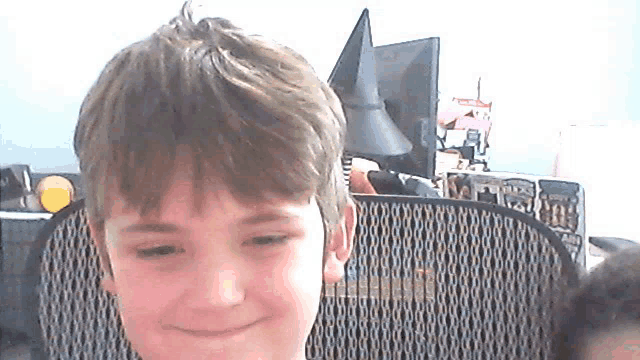 a young boy sitting in front of a computer monitor