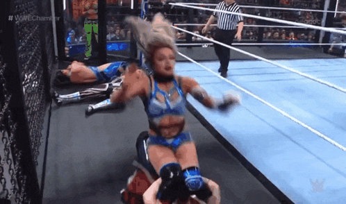 a woman is wrestling a man in a ring while a referee watches .