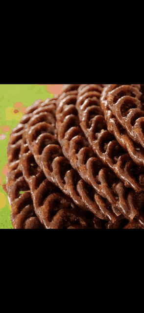 a close up of a stack of chocolate covered pretzels on a table