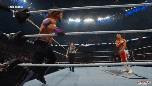 two wrestlers in a ring with the words lyon france on the top