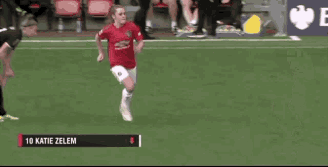a female soccer player named katie zelen is running on a field
