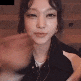 a close up of a woman 's face with headphones on .