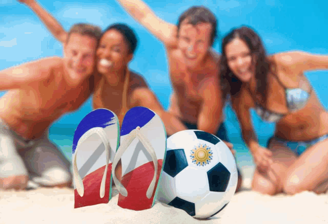 a group of people on a beach with flip flops and a soccer ball with the argentina flag on it