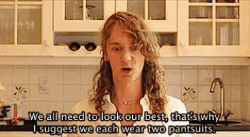 a woman in a kitchen says we all need to look our best that 's why i suggest we each wear two pantssuits