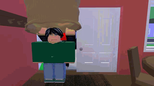 a boy in a green nike shirt stands in a room