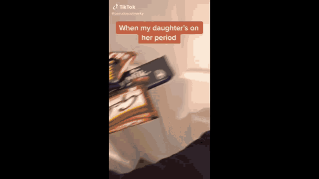a woman is standing in a room with her daughter 's period on her period .