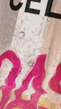a close up of a bottle of chanel with bubbles in it