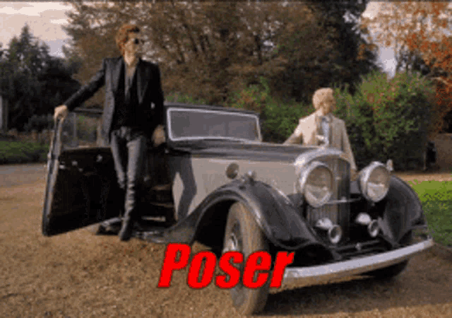 a man in a suit is standing next to an old fashioned car with the word poser on it