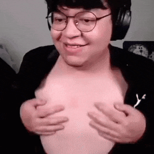 a man wearing glasses and headphones is holding his breasts .