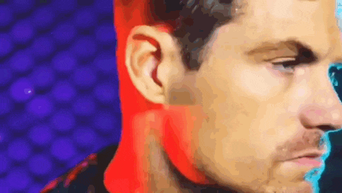 a close up of a man 's face with a colorful background
