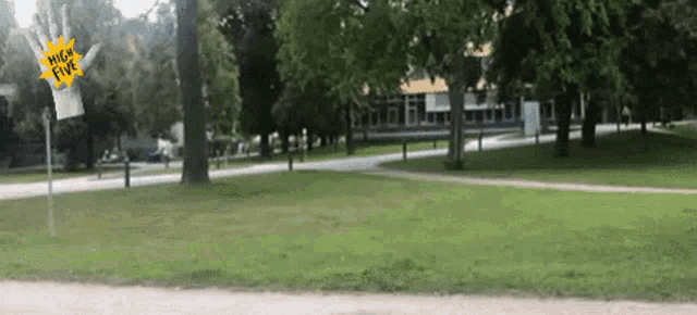 a park with trees and a sign that says high five on it