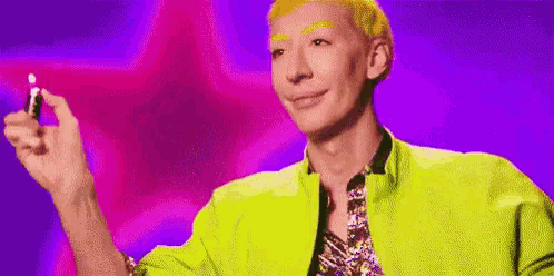 a man in a neon yellow jacket is holding a lighter in his hand and smiling .