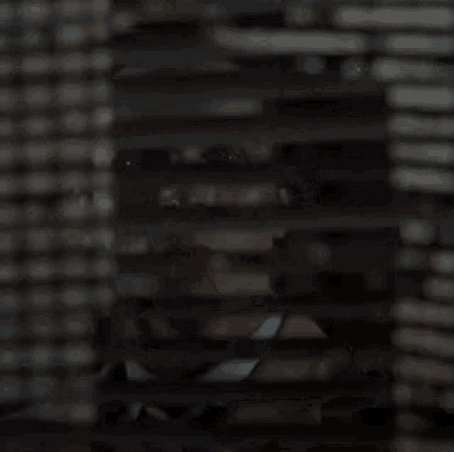 a man in a suit and tie is looking out of a window .