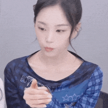 a girl wearing a blue shirt with boy on it