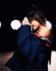 ariana grande is wearing boxing gloves and a crop top while kneeling down on a stage .