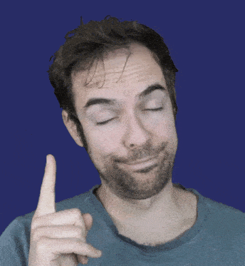 a man with his eyes closed is pointing up