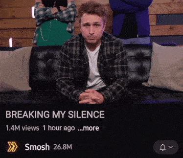 a man in a plaid shirt sits on a couch with the words " breaking my silence " on the top