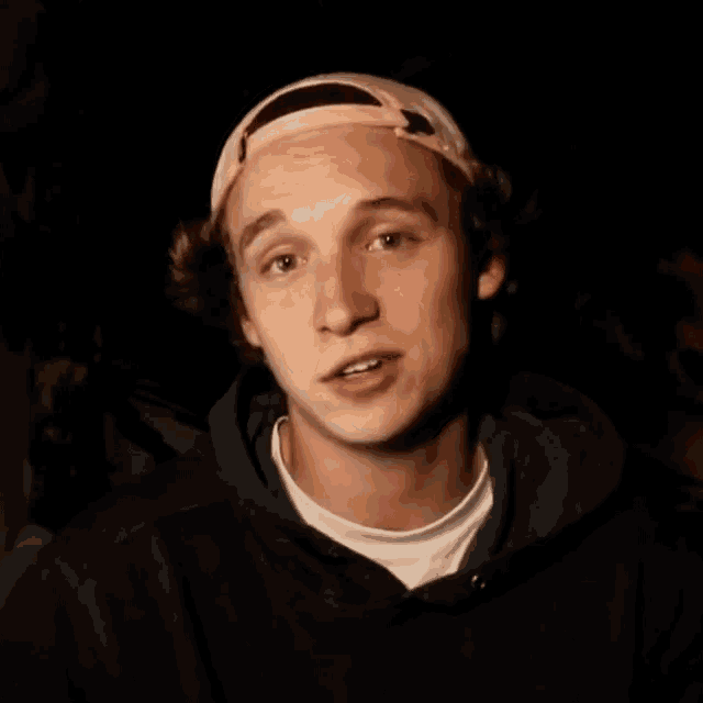 a young man wearing a pink hat is smiling with the words that mother fucker above him