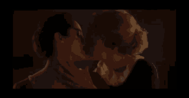 two women are kissing in a dark room in a movie