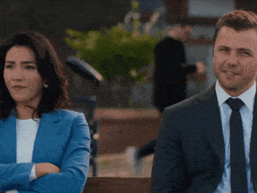 a man and a woman sitting next to each other on a bench