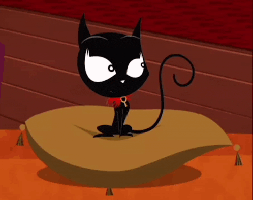 a black cat is sitting on a pillow with a red rose around its neck