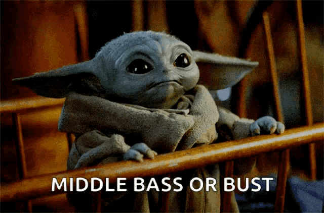 a baby yoda sitting on a wooden railing with the words middle bass or bust written below him