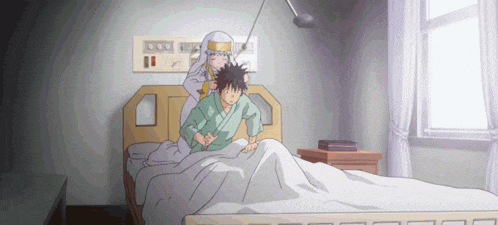 a man is laying in a hospital bed while a woman stands behind him