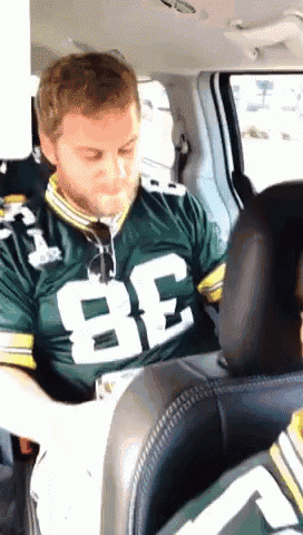 a man in a green jersey with the number 82 on it