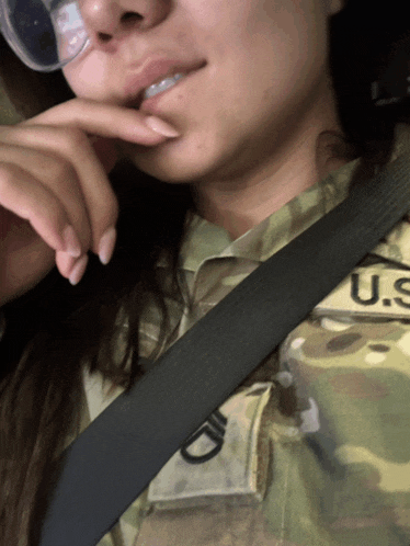 a woman wearing a u.s. army uniform with a seat belt around her waist