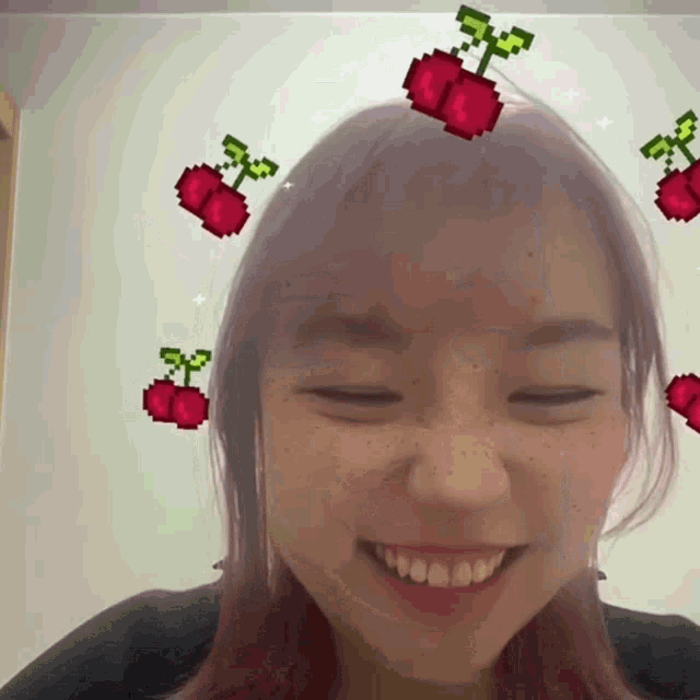 a girl with pixelated cherries on her head smiles