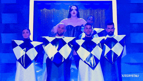 a group of people standing in front of a screen that says xtecrystali on the bottom