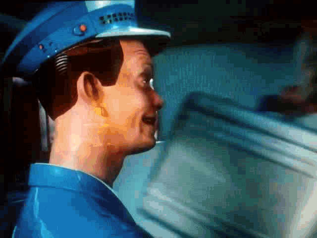 a close up of a man wearing a blue uniform and hat