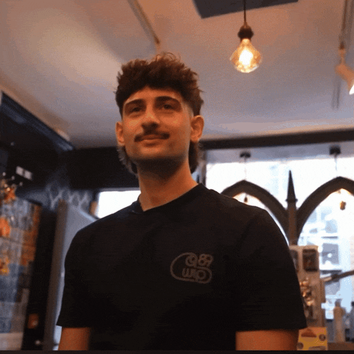 a man wearing a black t-shirt with the number 989 on it
