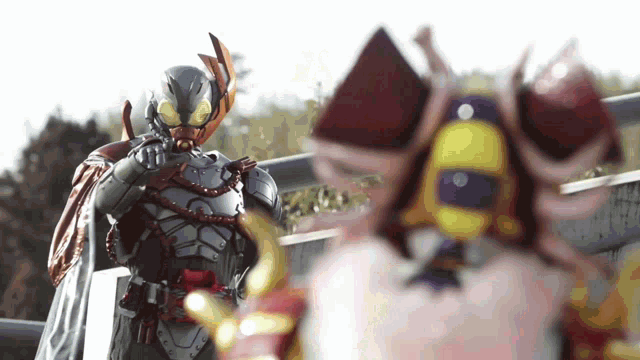 a man in a robot costume is standing next to another man in a costume .