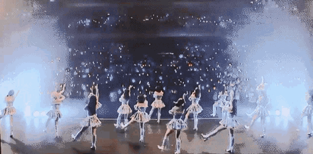 a group of women are dancing on a stage in a pixelated image
