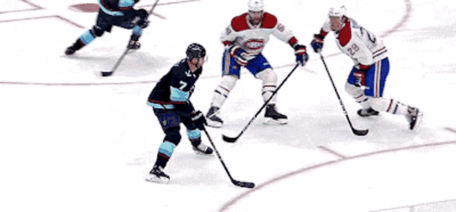 a hockey player with the number 28 on his jersey stands on the ice