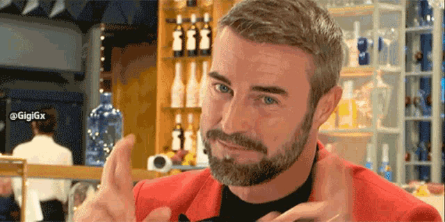 a man with a beard is giving a thumbs up