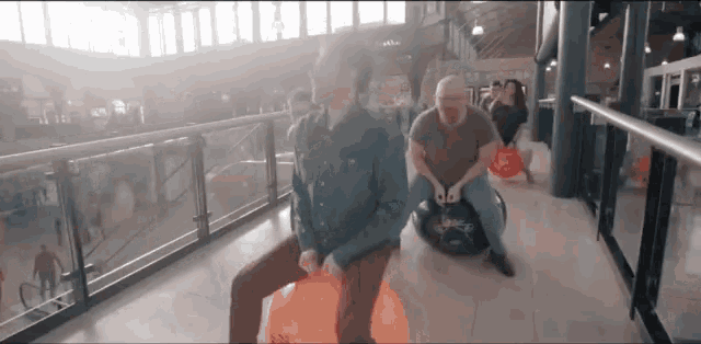 a man is sitting on a bouncy ball that says ' s' on it