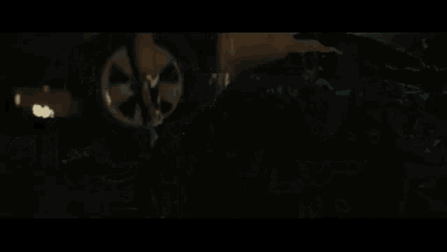 a woman in a suicide squad costume is standing next to a car .